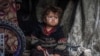 A displaced Palestinian child sitting in a tent at a camp in the city of Rafah, Gaza, in March. 