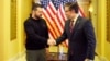 Ukrainian President Volodymyr Zelenskiy (left) shakes hands with the speaker of the U.S. House of Representatives, Mike Johnson, in Washington on December 12.