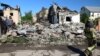 Ukrainian emergency workers deal with the aftermath of Russian shelling overnight on a district in Kharkiv on May 10. 