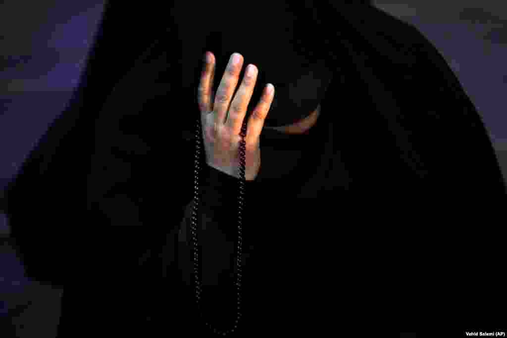 An Iranian woman prays for President Ebrahim Raisi in Tehran on May 19 after it was reported that the helicopter carrying Raisi and his entourage crashed in northwestern Iran. Iranian Supreme Leader Ayatollah Ali Khamenei&nbsp;declared five days of mourning&nbsp;after the bodies of Raisi, 63, and Foreign Minister Hossein Amir-Abdollahian, 60, were found at the site of a helicopter crash on May 20.