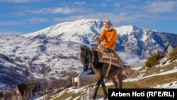 Shate Palinci rides her mule to water in Borje, a village in Albania. Residents of Borje largely rely on a nearby town across the border in Kosovo for supplies and medical treatment.