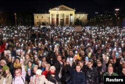 People take part in a demonstration after the resignation of the country's President Katalin Novak and former Justice Minister Judit Varga in Budapest on February 16.