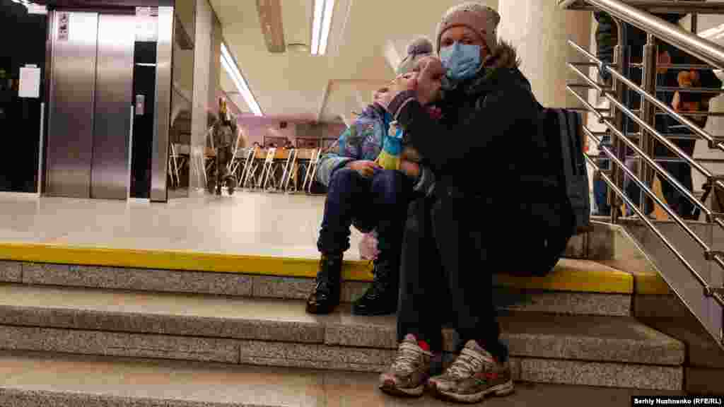 A woman hugs her child in a subway station in Kyiv during the first day of the Russian invasion on February 24, 2022.