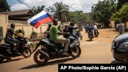 Supporters of a coup in Burkina Faso wave a Russian flag in October 222.