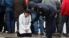 A Russian police officer approaches a woman outside the Crocus City Hall in the Moscow region following a deadly attack at the concert venue on March 22. 