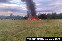 The burning wreckage of a plane in which Wagner chief Yevgeny Prigozhin is believed to have been a passenger on August 23.