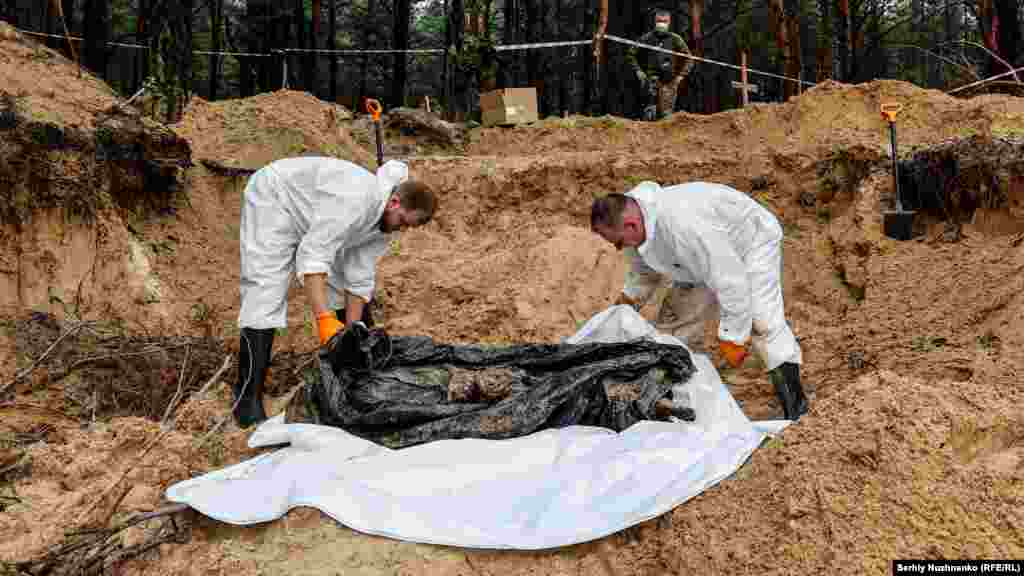 The body of a Ukrainian soldier, found with his hands tied behind his back, in a mass grave near Izyum, in the Kharkiv region, on September 16, 2022.