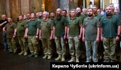 Military chaplains who completed advanced training courses on chaplaincy of the Ukrainian armed forces attend a graduation ceremony in Kyiv on June 23, 2023.