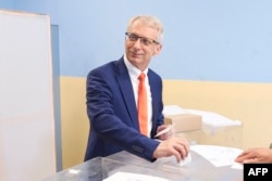 Former Prime Minister Nikolay Denkov casts his ballot at a polling station in Sofia on June 9.