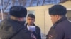 Russian police confront a Central Asian migrant. 