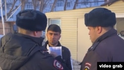 Russian police confront a Central Asian migrant. 