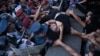 Antigovernment activists clash with Armenian police officers during a protest in Yerevan on June 12.