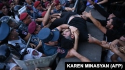 Antigovernment activists clash with Armenian police officers during a protest in Yerevan on June 12.