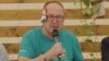 Hungarian Fidesz lawmaker Zsolt Nemeth with a folded paper "bandage" over his ear at the Tusvanyos Festival in eastern Transylvania on July 24.