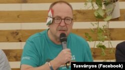 Hungarian Fidesz lawmaker Zsolt Nemeth with a folded paper "bandage" over his ear at the Tusvanyos Festival in eastern Transylvania on July 24.