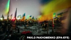 Ukrainian flags fly over the graves of fallen Ukrainian soldiers at a military cemetery in Kharkiv, northeastern Ukraine, on February 22.