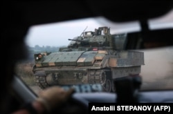 A U.S.-supplied Bradley infantry fighting vehicle drives on a road not far from the city of Toretsk.