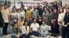 A group photo of Azki.com employees shows many of the women not wearing the mandatory head scarf.