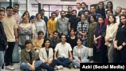 A group photo of Azki.com employees shows many of the women not wearing the mandatory head scarf.