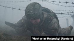 A new recruit of the 1st Da Vinci Wolves Separate Mechanized Battalion attends a military exercise in an undisclosed location in central Ukraine on March 12.