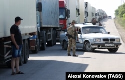 Trucks wait to pass the Armyansk checkpoint between the Kherson region and Crimea on June 23. The photo was taken one day after the Chonhar bridge was damaged in a missile strike and closed to traffic.