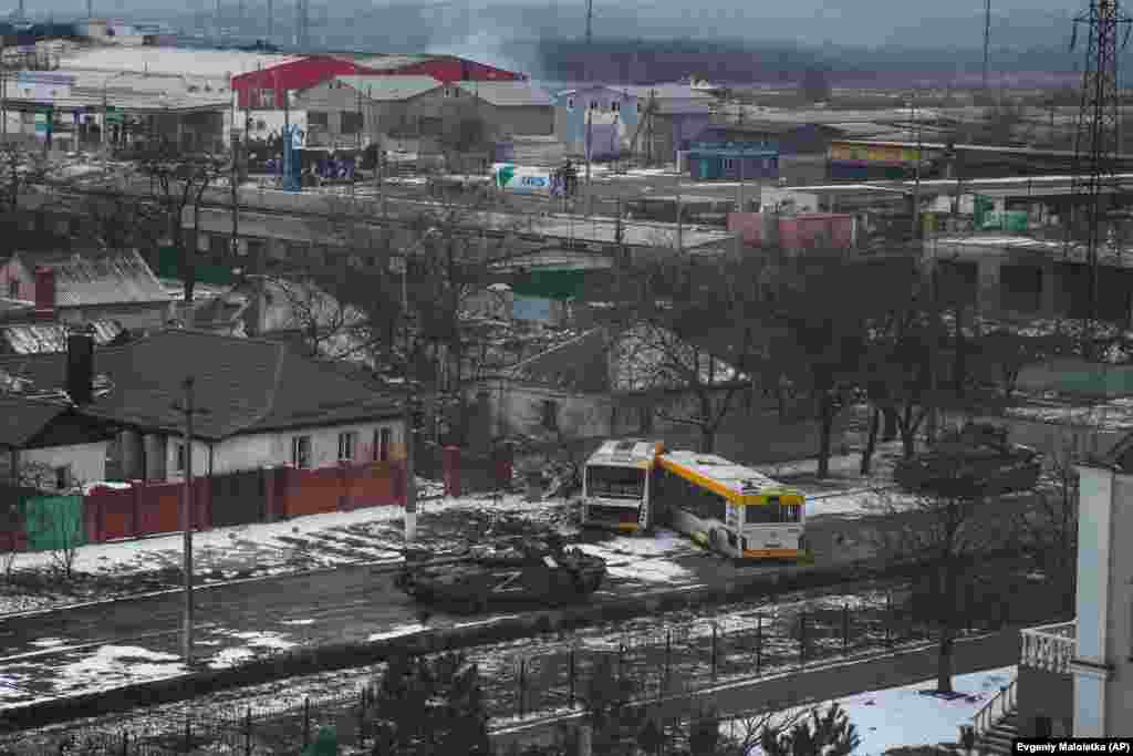 Russian Army tanks move through a street on the outskirts of Mariupol, Ukraine, on March 11, 2022. World Press Photo, Europe, Stories: The Siege Of Mariupol by Evgeniy Maloletka, AP &nbsp;