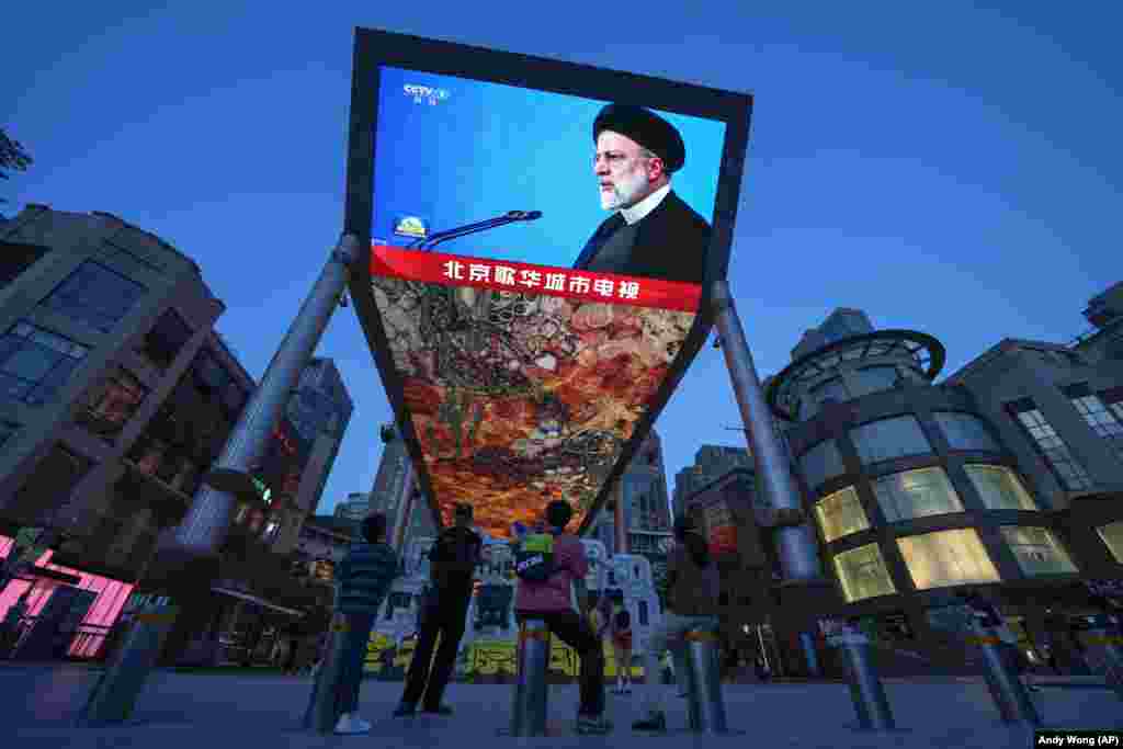 Pedestrians in Beijing watch a large screen showing footage of Raisi announcing the news of his death. Chinese President Xi Jinping called Raisi&#39;s death &quot;tragic&quot; and said that &quot;the Chinese people have lost a good friend,&quot; a spokesman for China&#39;s Foreign Ministry said. &nbsp;