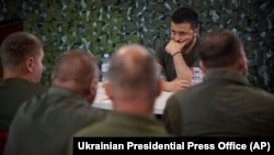 Ukrainian President Volodymyr Zelenskiy with servicemen during his visit earlier this week to the headquarters of brigades at the front line near Soledar in the Donetsk region. 