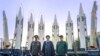 President Ebrahim Raisi (center) stands in front of Iranian missiles with other top officials last August.