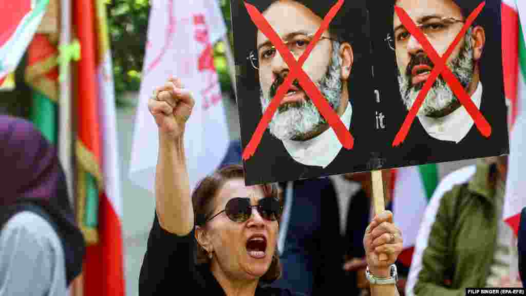 An anti-government protester holds a placard of Raisi in front of the Iranian Embassy in Berlin. Raisi was dubbed the &quot;Butcher of Tehran&quot; for his role as one of the judges who oversaw the executions of thousands of political prisoners in the late 1980s.