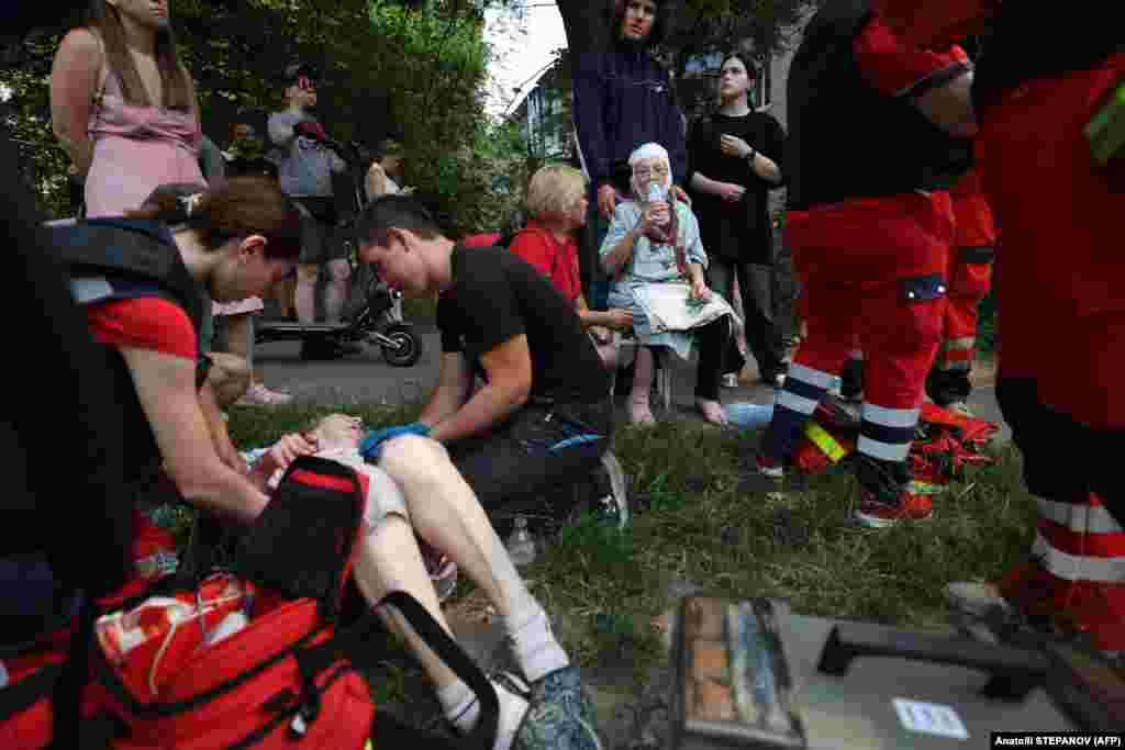 First responders tend to the wounded at the residential area. The Russian Defense Ministry said allegations by Kyiv that it had deliberately targeted civilian infrastructure in the strike were &quot;absolutely untrue.&quot;