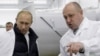 Businessman-turned mercenary leader Yevgeny Prigozhin (left) shows Russian Prime Minister Vladimir Putin his school lunch factory outside St. Petersburg in 2010.