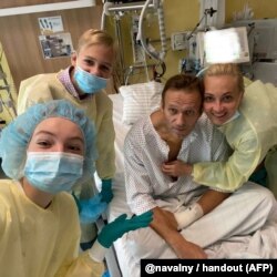 Navalny poses with his family in September 2020 at Berlin's Charite hospital, where he was recovering from a near-fatal poisoning attack.