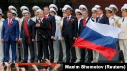 Russian President Vladimir Putin (third left) makes a speech standing with Crimean parliamentary speaker Vladimir Konstantinov (second left), then-Crimean Prime Minister Sergei Aksyonov (fourth left) and other top officials in Sevastopol in 2014. 