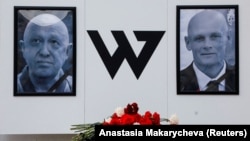 Portraits of Yevgeny Prigozhin (left), head of the Wagner mercenary group, and Dmitry Utkin, group commander, are seen at a makeshift memorial in Nizhny Novgorod, on August 27, 2023.