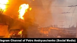 A trolleybus burns on the ramp of the Dnipro hydroelectric power station after Russian attacks on March 22.