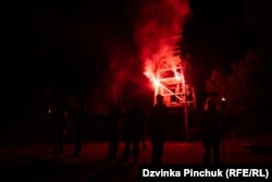 Participants at the Call Of The Ravine youth camp at a nighttime ritual in which they acquire new nicknames.