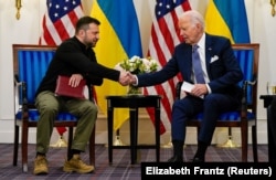 Ukrainian President Volodymyr Zelenskiy and U.S. President Joe Biden meet in Paris on June 7.