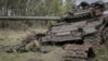 The body of a Russian soldier is seen near a destroyed Russian tank in the newly liberated village of Storozheve in Ukraine's Donetsk region on June 14.