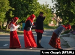 Lipovans cross themselves with two fingers as they pass a church in the village of Sarichioi.