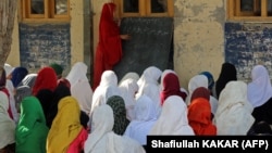 Afghan girls attend their classes at a primary school in Bati Kot, a rural district in the eastern province of Nangarhar.