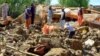 Afghans search through a building destroyed by heavy flooding earlier this month. Afghanistan has suffered a series of disastrous inundations this year