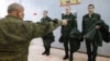 Russian conscripts try on uniforms at a local draft office before departing for military service. (file photo)