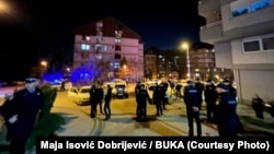 Police gather outside the Transparency International office after an attack on activists on March 18.