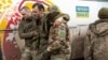 A Ukrainian POW is helped by colleagues after he was released from Russian captivity in a prisoner exchange at an unknown location in Ukraine. (file photo) 