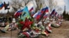 Flags wave over the recent graves of Russian soldiers killed in Ukraine at a cemetery in Russia’s Volgograd region.