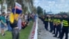 Protesters held banners with slogans decrying Russia's war in Ukraine and President Vladimir Putin for launching the invasion.