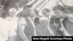 Sami Begolli (center left) stands next to his grandmother in a camp for refugees in Blace, in what is now North Macedonia, in April 1999.