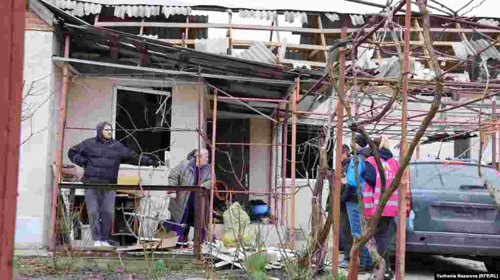 Emergency responders and aid workers speak with local residents whose homes were damaged during the Russian missile strike. President Volodymyr Zelenskiy said the assault involved 150 drones and missiles and once more appealed to Ukraine&#39;s allies to speed up deliveries of critically needed ammunition and weapons systems.