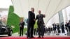 German Chancellor Olaf Scholz (right) shakes hands with the president of Tajikistan, Emomali Rahmon, in Berlin on September 29. Is that egg on the Tajik leader's car?